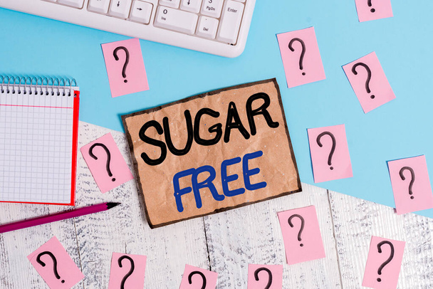 Writing note showing Sugar Free. Business photo showcasing do not contain sugar and only have artificial sweetener instead Writing tools and scribbled paper on top of the wooden table. - Photo, Image