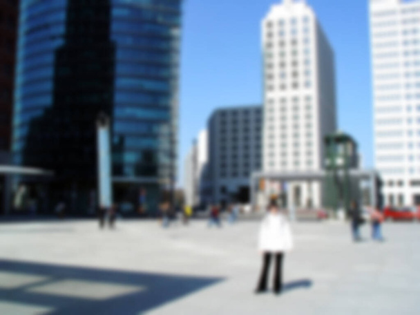 Defocused photography. Potsdamer Platz featuring the distinctive architecture of the Beisheim Centre, in Berlin, Germany. Blurred background copy space for your design - Photo, Image