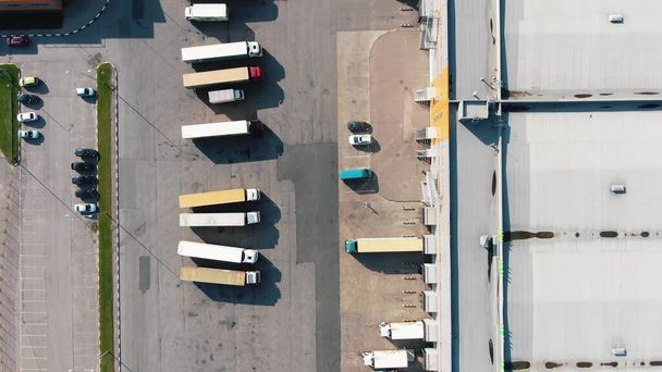 巨大な倉庫の近くの駐車場の異なるトラック空中 - 写真・画像