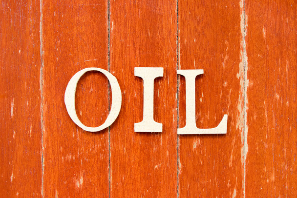 Alphabet letter in word oil on old red color wood plate background - Fotografie, Obrázek