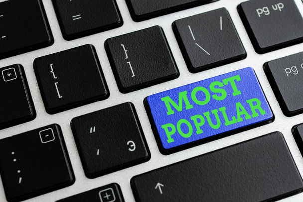 Text sign showing Most Popular. Conceptual photo Liked Followed Enjoyed by majority of the showing in a society Different Colored PC keyboard key With Accessories on Empty background. - Photo, Image