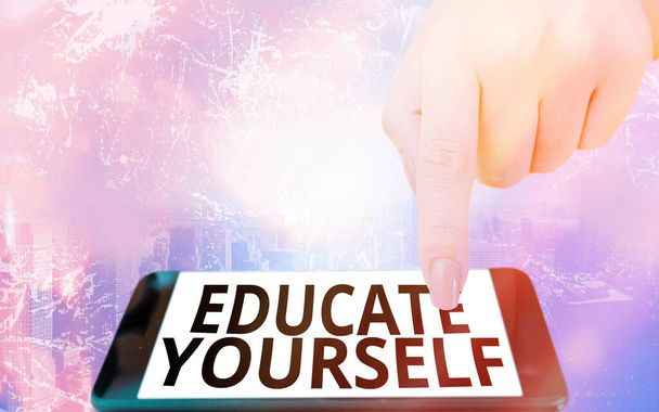 Conceptual hand writing showing Educate Yourself. Business photo text prepare oneself or someone in a particular area or subject Modern gadgets white screen under colorful bokeh background. - Photo, Image