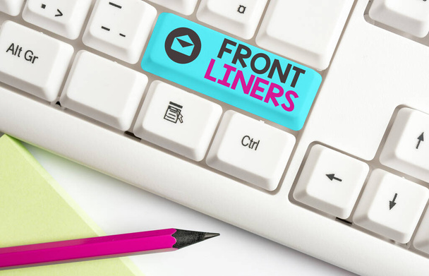 Handwriting text Frontliners. Concept meaning most important or influential position in a debate or movement. Different colored keyboard key with accessories arranged on empty copy space. - Photo, Image
