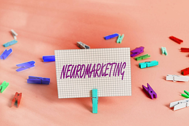 Writing note showing Neuromarketing. Business photo showcasing field of marketing uses medical technologies such as fMRI Colored crumpled rectangle shaped reminder paper light blue background. - Photo, Image