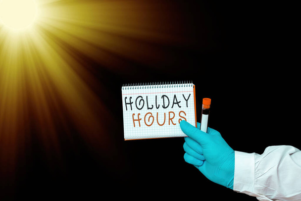 Conceptual hand writing showing Holiday Hours. Business photo showcasing employee receives twice their normal pay for all hours Displaying Sticker Paper Accessories With Medical Gloves On. - Photo, Image