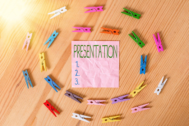 Conceptual hand writing showing Presentation. Business photo text act, power, or privilege especially of a patron of applying Colored crumpled papers wooden floor background clothespin. - Photo, Image