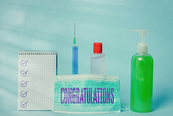 Writing note showing Congratulations. Business photo showcasing a congratulatory expression usually used in plural form Set of medical equipment with notepad for health condition assessment. - Photo, Image