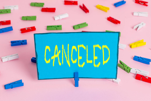 Text sign showing Canceled. Conceptual photo to decide not to conduct or perform something planned or expected Colored clothespin papers empty reminder pink floor background office pin. - Photo, Image