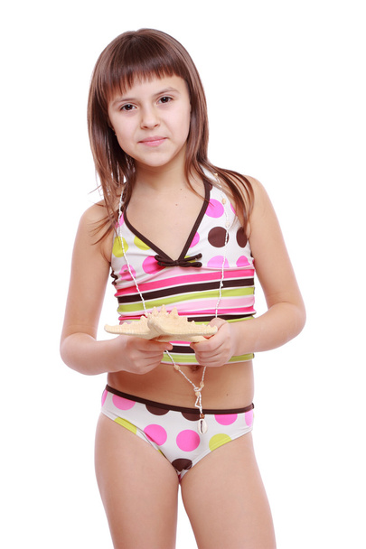 Girl in a swimsuit holding a starfish - Zdjęcie, obraz