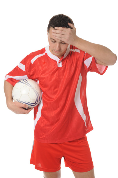 Upset soccer player in the red form. - Fotoğraf, Görsel