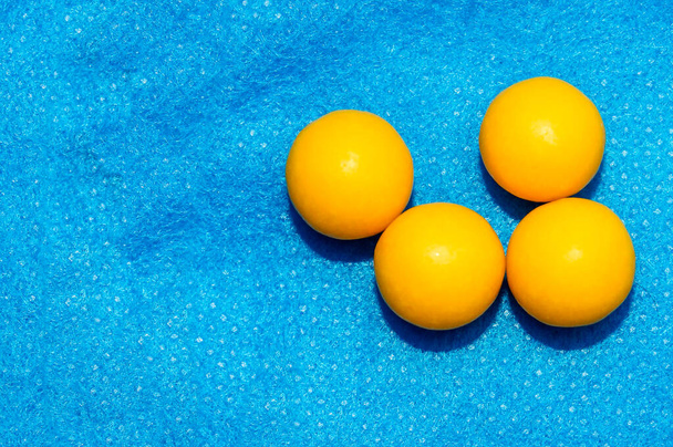 Ascorbic acid balls with vitamin C on a blue background. Prevention of colds. Close up. - Photo, Image