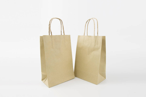 Close-up the paper shopping bag blank or without logo isolated on a white background. - 写真・画像