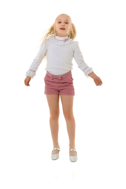 The little girl is jumping fun.The concept of a good mood, summer vacation. - Φωτογραφία, εικόνα