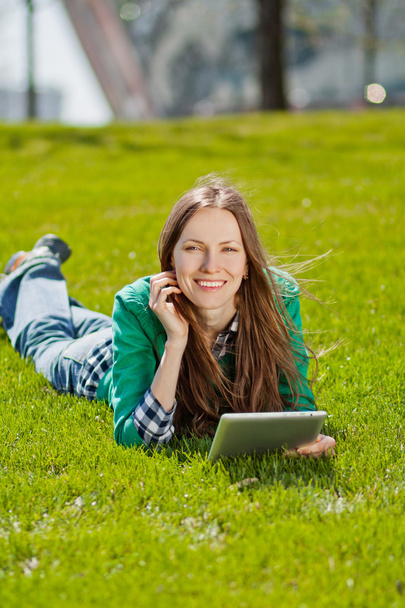 Young woman using tablet outdoor - Fotoğraf, Görsel