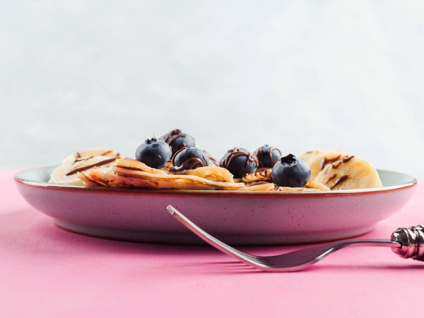 Eating crepes with chocolate and blueberries - Photo, Image