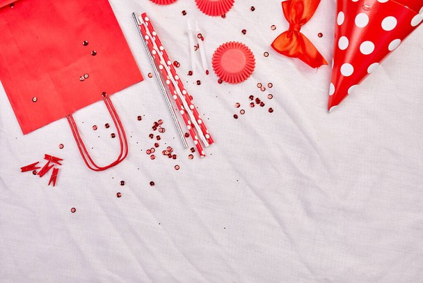 Birthday flat lay, top view and copy space for text, frame or background with red festival items, party hats and streamers, Birthday or party greeting card - Φωτογραφία, εικόνα