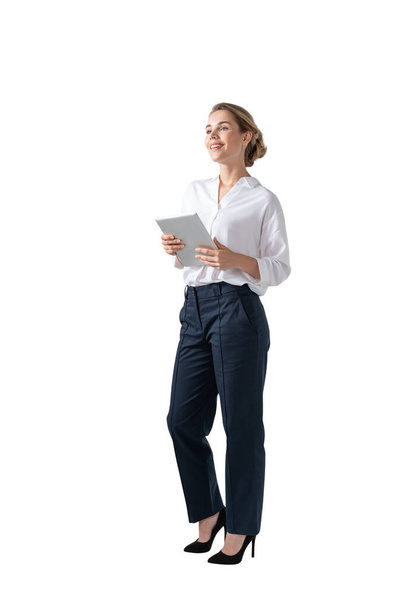 Isolated portrait of young smiling businesswoman standing with tablet computer. Concept of planning - Foto, Bild