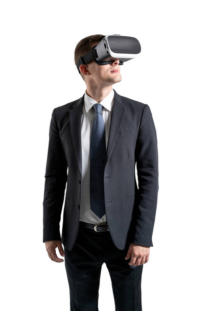 Portrait of young man using virtual reality glasses and gesturing over black background. - Fotó, kép