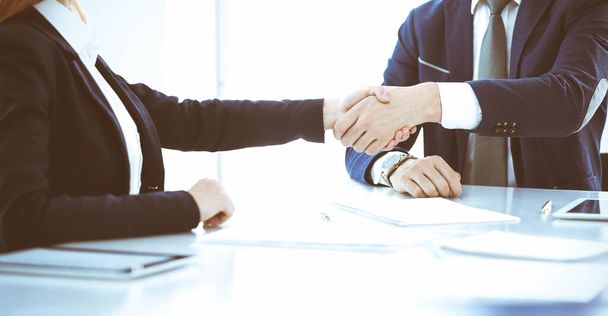 Business people or lawyers shaking hands finishing up a meeting, close-up. Negotiation and handshake concepts - Фото, зображення