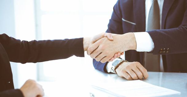 Business people or lawyers shaking hands finishing up a meeting, close-up. Negotiation and handshake concepts - Photo, image