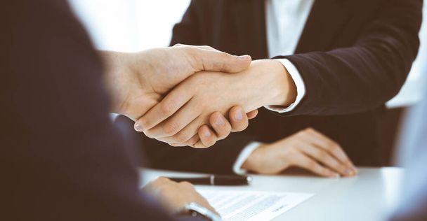 Business people or lawyers shaking hands finishing up a meeting, close-up. Negotiation and handshake concepts - Photo, Image