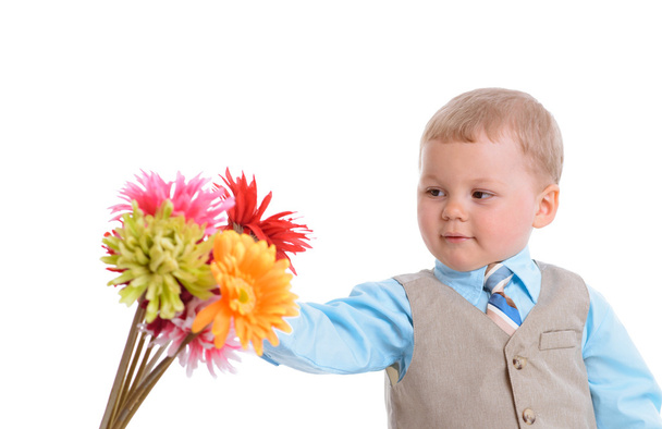 little boy with flowers - Фото, изображение