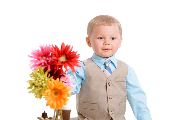 little boy with flowers - Фото, изображение