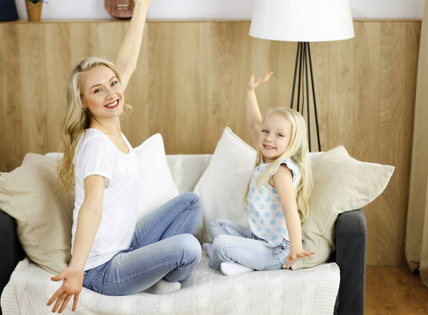 Happy family. Blonde young mother playing and hugging with her cute daughter. Motherhood concept - Φωτογραφία, εικόνα