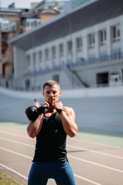 Sportive guy training with kettlebell. Strength and motivation. - Valokuva, kuva