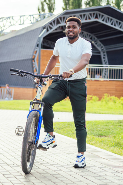 ecology and transportation concept. modern young Afro American businessman cycling to work on bicycle - Valokuva, kuva