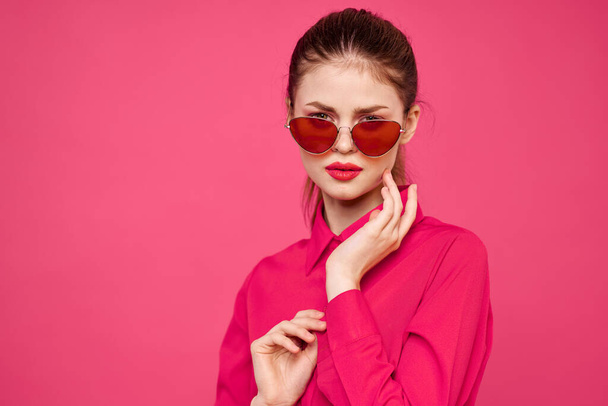 Woman in pink shirt and brown glasses cropped view fashion model emotions gesturing hands portrait - Foto, immagini