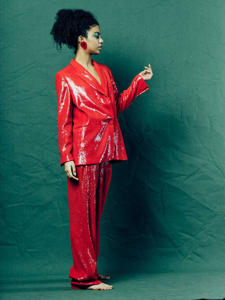 woman in red shiny suit decoration glamor luxury glamor  - 写真・画像