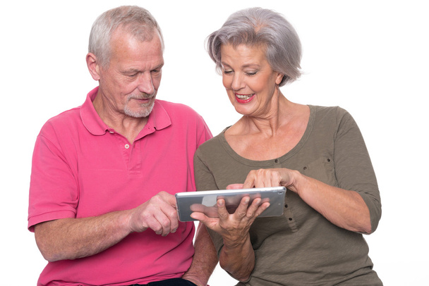 Senior couple with tablet  - Фото, изображение