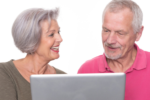 Senior couple with computer - 写真・画像
