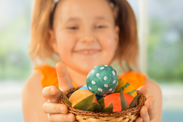 Girl gives Easter basket with eggs - Fotoğraf, Görsel