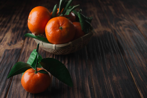 Fresh tangerines with leaves on a wooden old background - Φωτογραφία, εικόνα