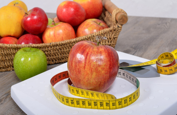 Apple placed on a scales, - Photo, Image