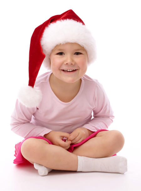 Little girl wearing red Christmas cap - Foto, imagen