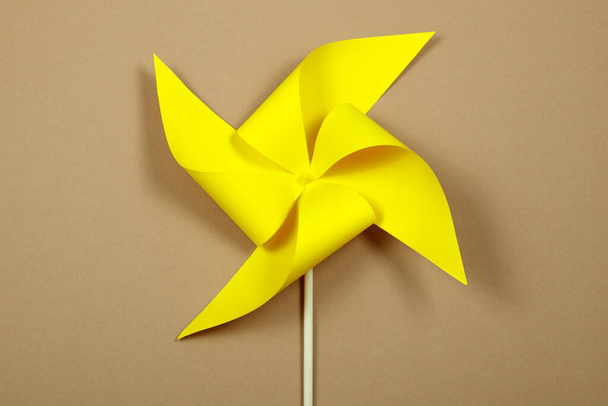 Yellow windmill on the beige background. - Photo, Image