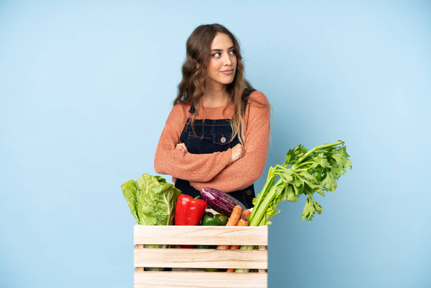 Farmer with freshly picked vegetables in a box portrait - Фото, изображение