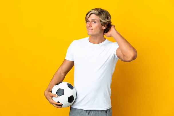 Inglés jugador de fútbol sobre aislado amarillo fondo tener dudas - Foto, imagen
