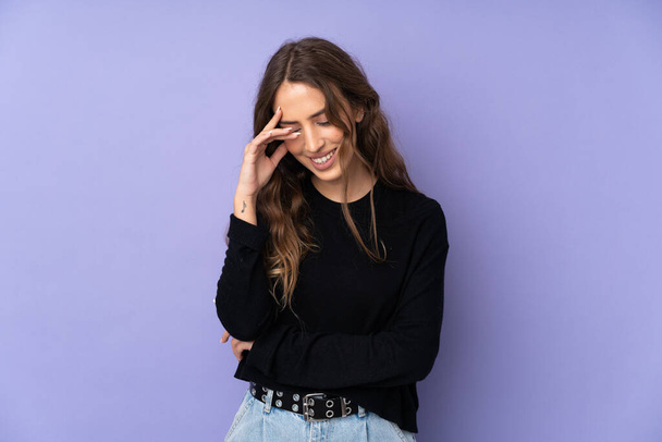 Young woman over isolated purple background laughing - Photo, Image