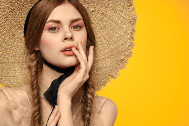 Portrait woman in straw hat on yellow background cropped view of summer dress model pigtails romance - Photo, Image
