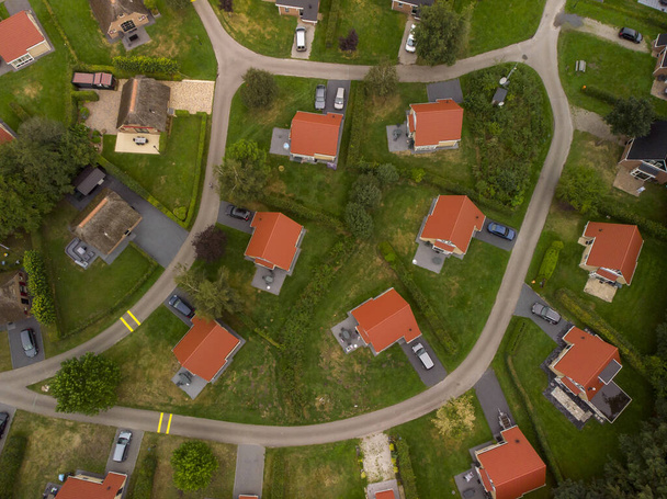 Top down view of meandering alley through a bungalow park summer homes with various style houses and rooftops - Photo, image