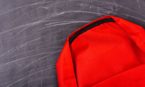 Back to school shopping pocket backpack on the education red bag on blackboard and chalkboard - Foto, afbeelding