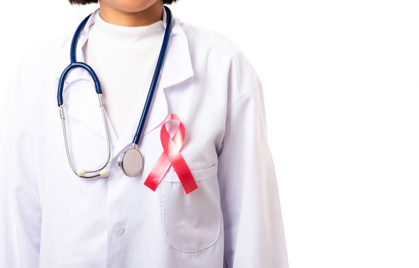 Vrouwelijke artsen in uniform met ondersteuning HIV AIDS bewustzijn rood lint op de borst in studio schot geïsoleerd op meer dan witte achtergrond, Gezondheidszorg en geneeskunde, Wereld aids dag concept - Foto, afbeelding