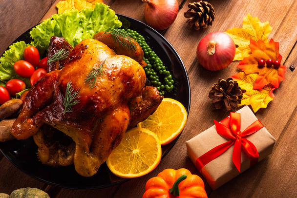 Thanksgiving roast turkey or chicken and vegetables, Top view Christmas dinner feast food decoration traditional homemade on wooden table background, Happy thanksgiving day of holiday concept - Zdjęcie, obraz
