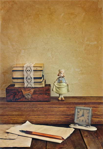 Vintage composition with books and porcelain doll. - Foto, imagen