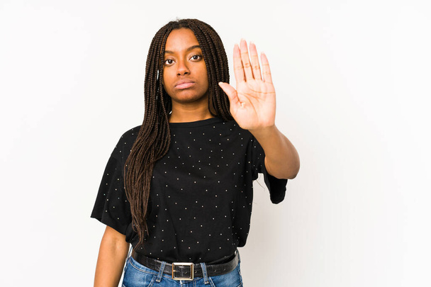 Young african american woman isolated on white background standing with outstretched hand showing stop sign, preventing you. - Foto, afbeelding