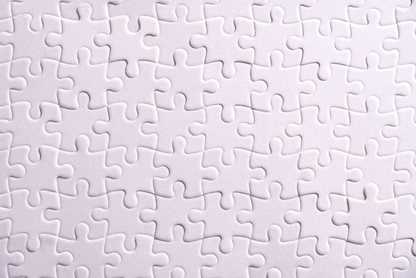 Puzzle background, white puzzle consists of many pieces - Zdjęcie, obraz